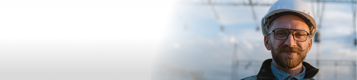 Electric utility employee in front of power lines