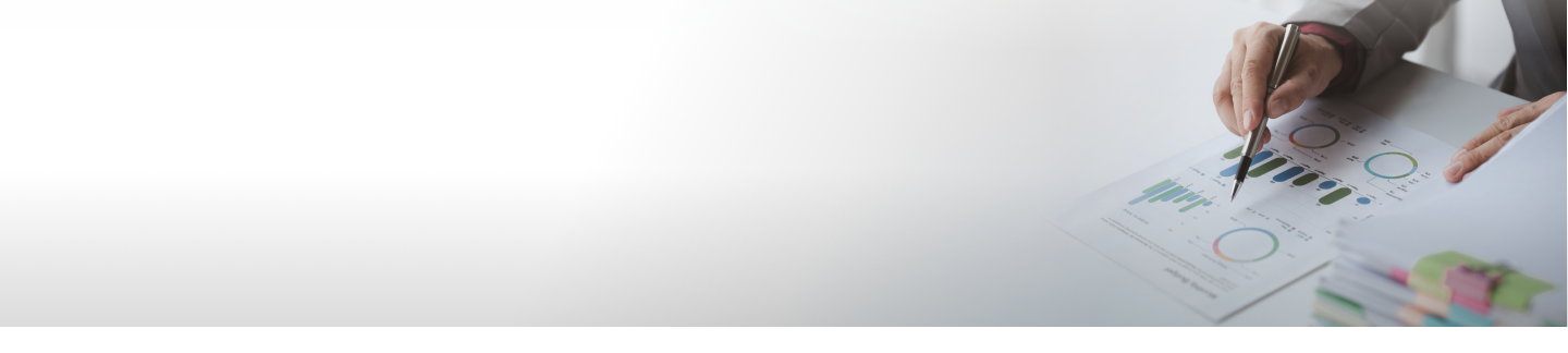 Man analyzing the document with chart and graph at the table.