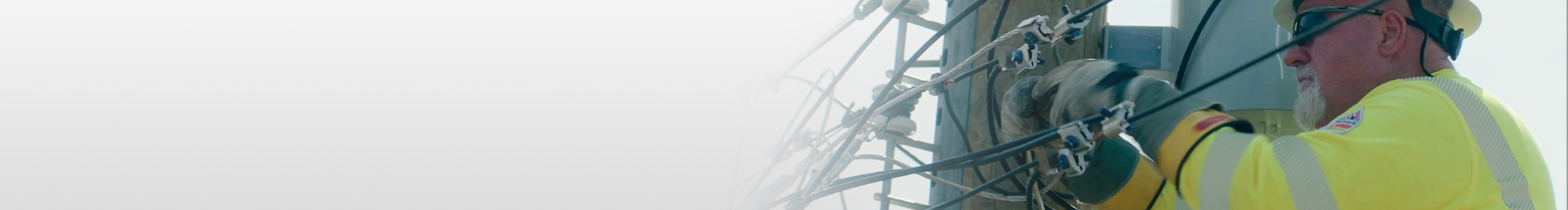 Lineman fixing wires on a powerline