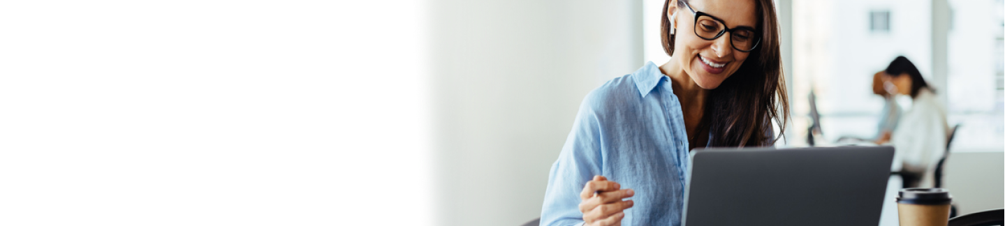Smiling woman looking at laptop